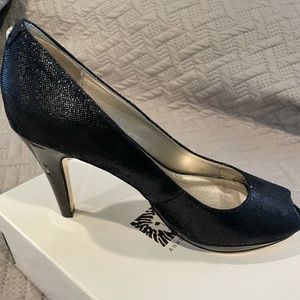 Anne Klein black snake skin pumps, with 3 1/2 inch patten leather heel. Size 9